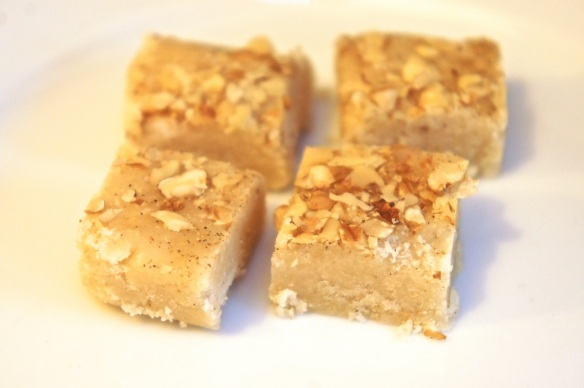 Four squares of almond fudge with walnuts